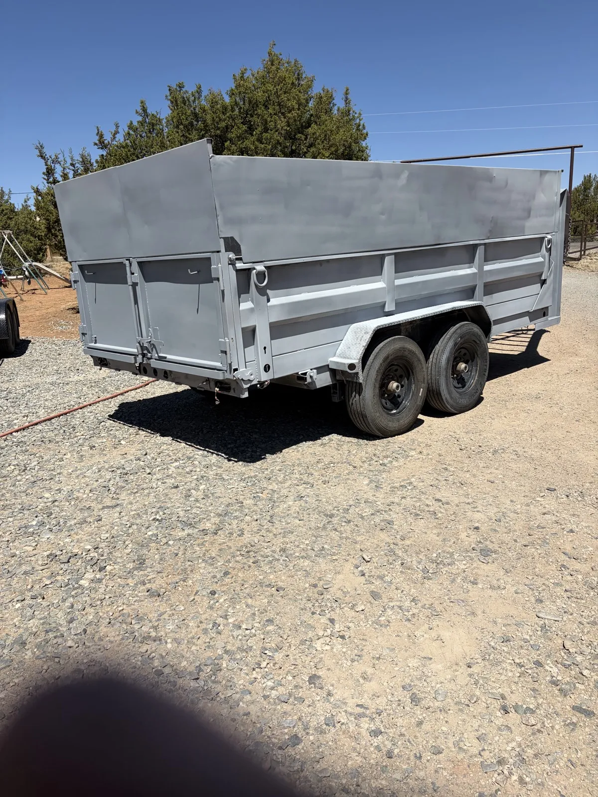 A dump trailer blasted back to clean bare steel, ready for coating.